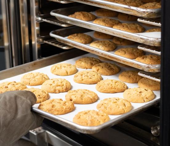 Racks of fresh-baked cookies in the bakery