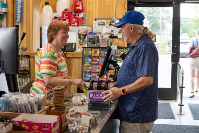 A cashier chatting with a customer at the front register