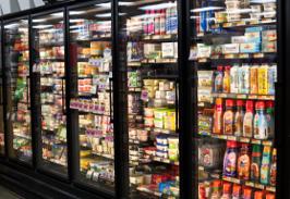 The dairy case stocked with butter, cheese, and creamers