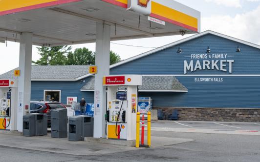 The gas canopy and 24-hour fueling sign in front of the market