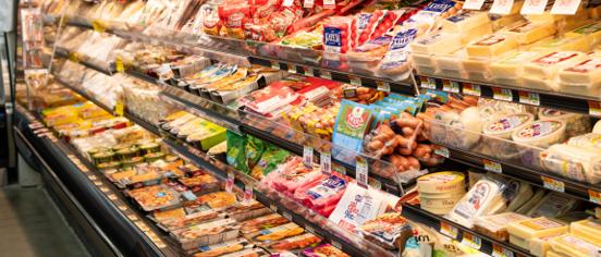 The deli case stocked with sliced meats and cheeses