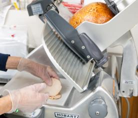 Ham being sliced to order on the deli slicer