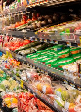 The produce case stocked with fresh vegetables, fruit, and berries